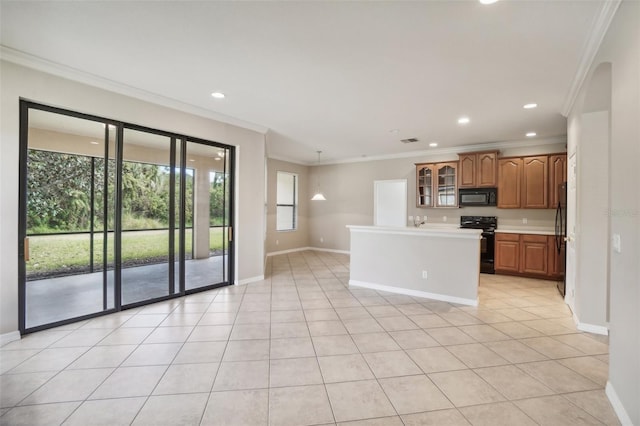 kitchen featuring light tile patterned floors, a center island, ornamental molding, and black appliances