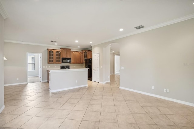 kitchen featuring light tile patterned flooring, crown molding, a kitchen island, and black appliances