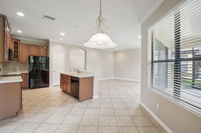 kitchen featuring light tile patterned floors, a center island with sink, hanging light fixtures, and black appliances