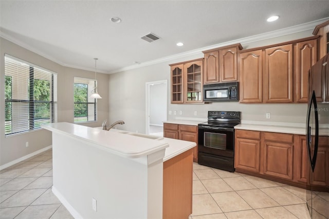 kitchen with pendant lighting, black appliances, sink, ornamental molding, and an island with sink