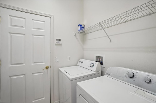 clothes washing area featuring washer and clothes dryer