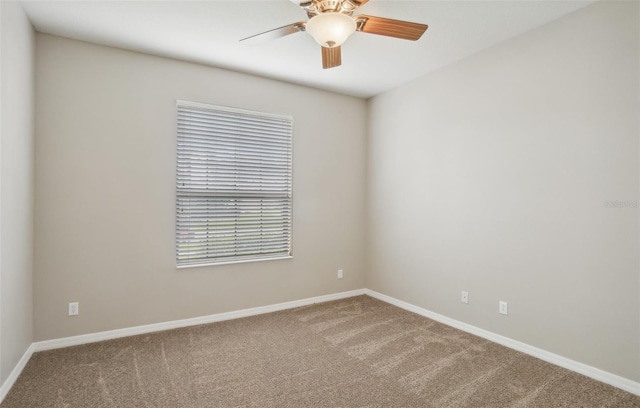 empty room with ceiling fan and carpet