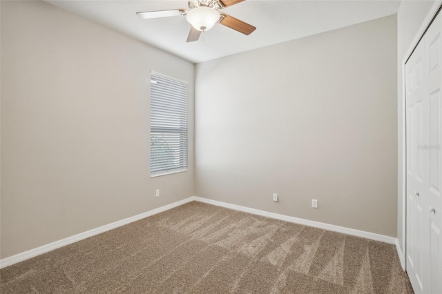 unfurnished bedroom featuring carpet, ceiling fan, and a closet