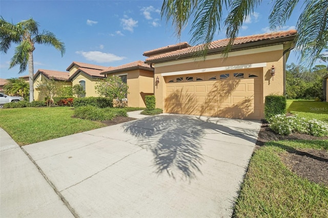 mediterranean / spanish house featuring a front yard and a garage