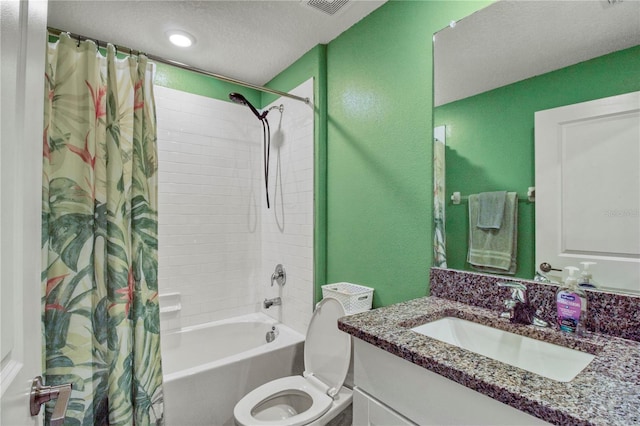 full bathroom featuring shower / bath combination with curtain, toilet, a textured ceiling, and vanity