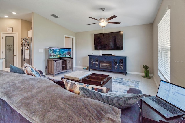 living room featuring ceiling fan and light tile patterned flooring