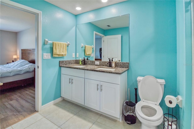 bathroom with hardwood / wood-style floors, vanity, and toilet