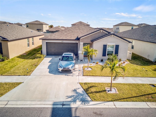 view of front of property with a garage and a front lawn