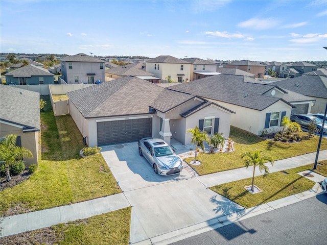 view of front of home featuring a garage and a front yard