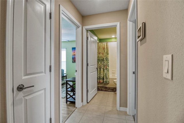 corridor with light tile patterned flooring