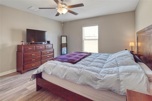 bedroom with light wood-type flooring and ceiling fan