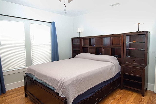 bedroom with ceiling fan and light hardwood / wood-style floors