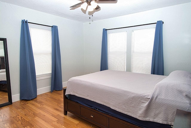 bedroom with light hardwood / wood-style flooring and ceiling fan