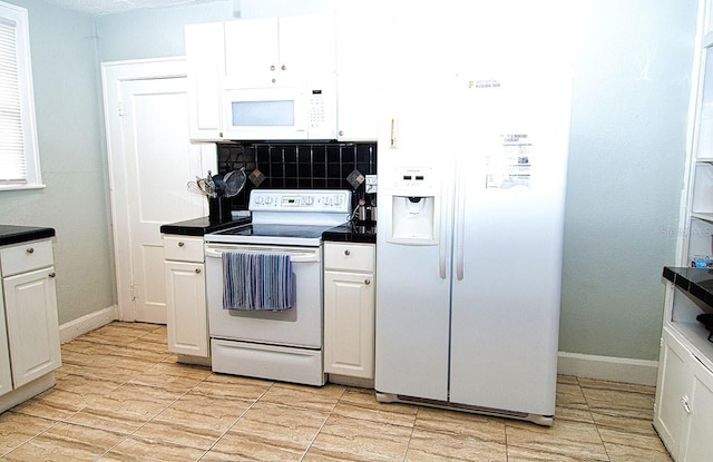 kitchen featuring white appliances, white cabinetry, and backsplash