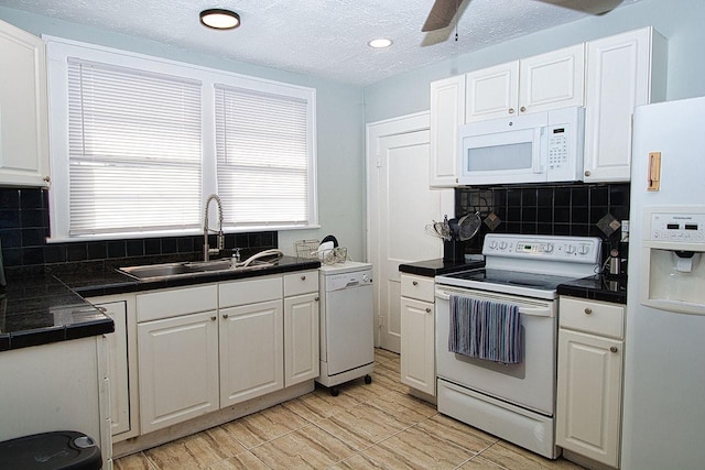 kitchen with white cabinets, plenty of natural light, white appliances, and sink