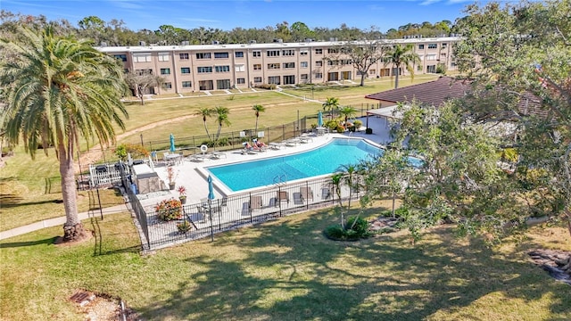 view of swimming pool with a patio area and a yard