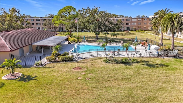 view of swimming pool with a yard and a patio area