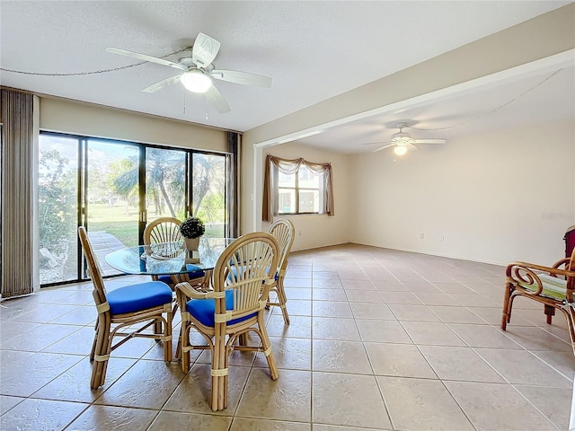 dining room featuring ceiling fan and light tile patterned flooring