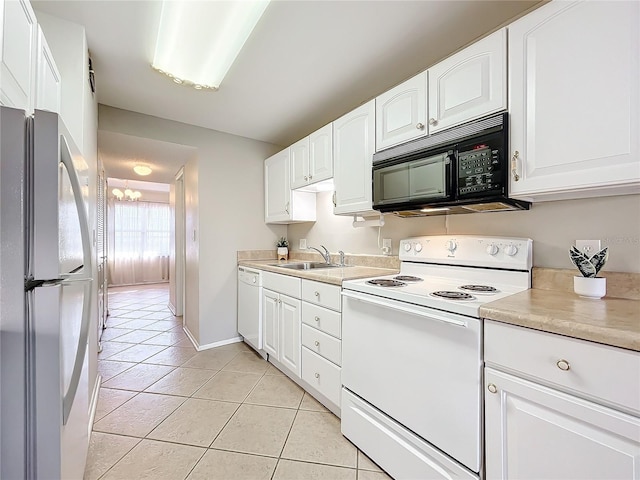 kitchen with sink, white cabinets, and white appliances