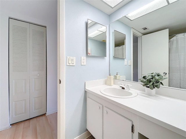 bathroom with hardwood / wood-style floors and vanity