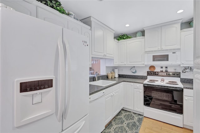 kitchen featuring white cabinetry, sink, white appliances, and light wood-type flooring