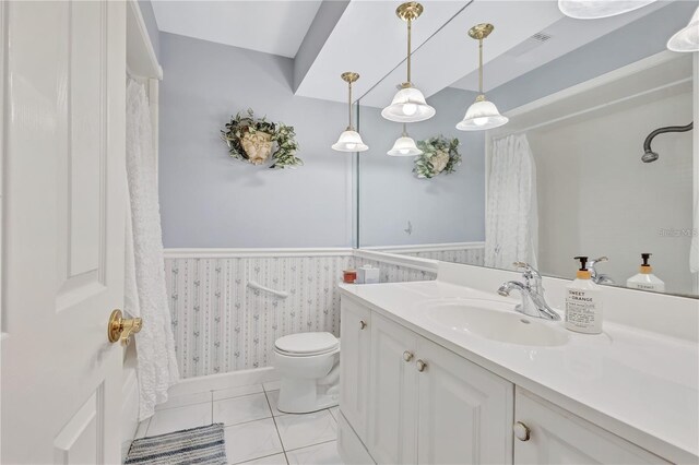 bathroom featuring toilet, vanity, and tile patterned floors