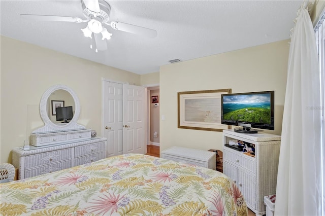 bedroom with ceiling fan and wood-type flooring