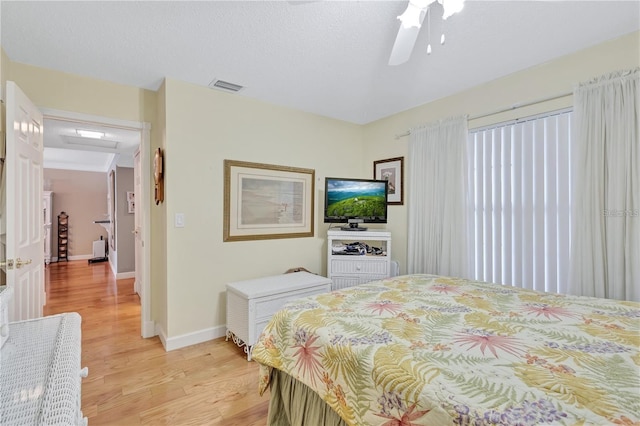 bedroom with ceiling fan and light hardwood / wood-style flooring