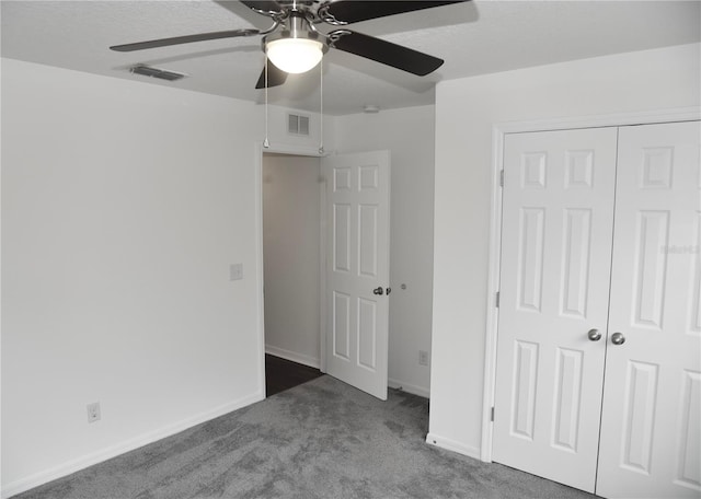 unfurnished bedroom with carpet flooring, ceiling fan, and a closet