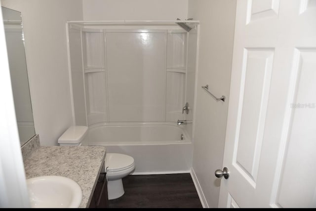 bathroom with shower / bathtub combination, toilet, wood finished floors, vanity, and baseboards