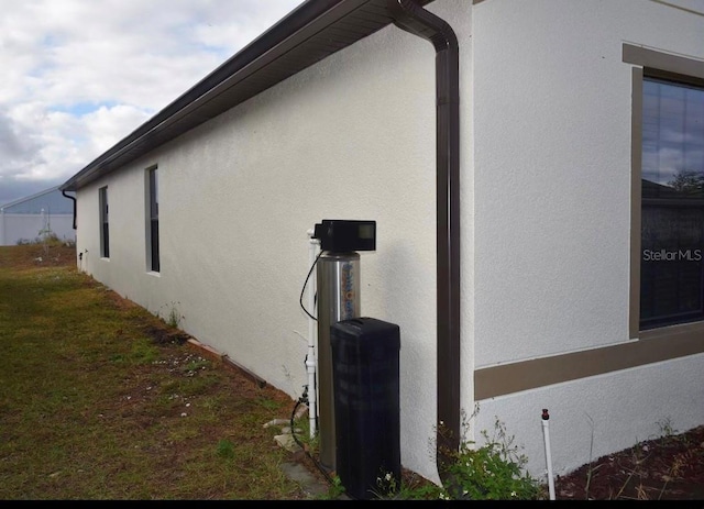 view of home's exterior with a yard and stucco siding