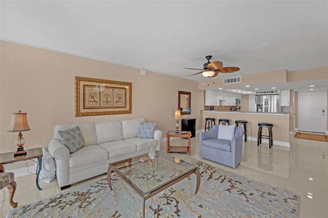 living room featuring light tile patterned floors and ceiling fan