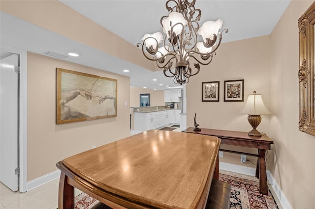 tiled dining space with an inviting chandelier