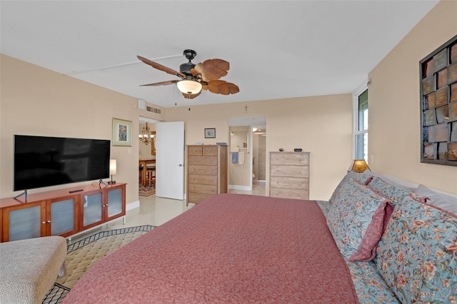 bedroom with ceiling fan with notable chandelier and connected bathroom