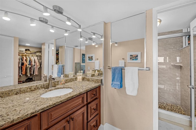 bathroom with vanity and tiled shower