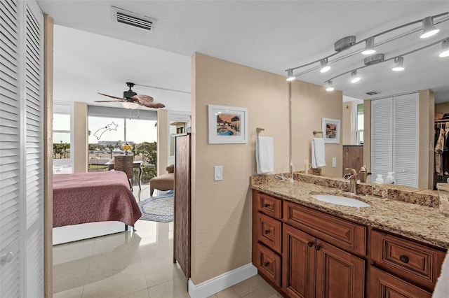 bathroom with vanity, rail lighting, tile patterned floors, and ceiling fan