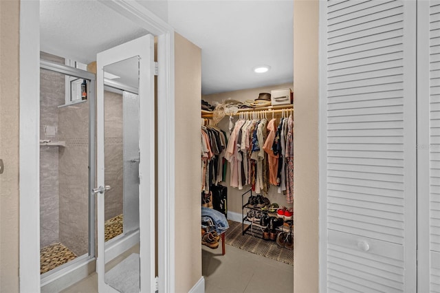 walk in closet featuring tile patterned flooring