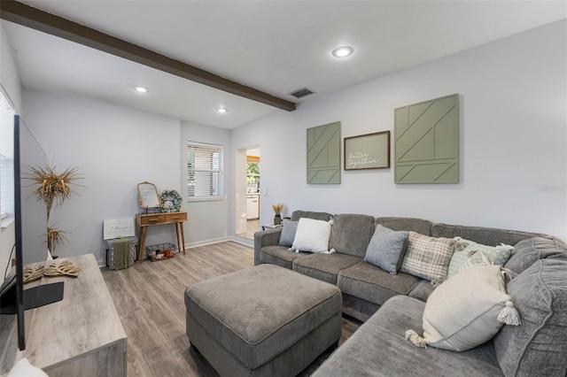 living room with beam ceiling and wood-type flooring