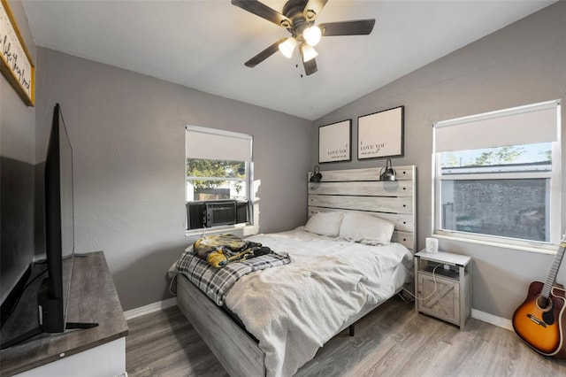 bedroom featuring wood-type flooring, cooling unit, ceiling fan, and lofted ceiling