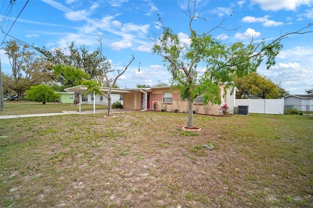 ranch-style house featuring central AC unit, a front yard, and fence