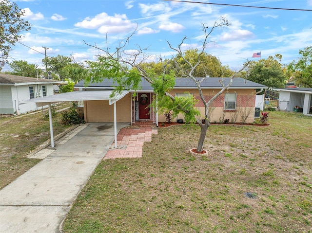 ranch-style house with a front yard, concrete driveway, brick siding, and an attached carport