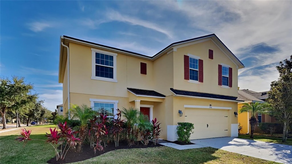 view of front of house featuring a garage and a front lawn