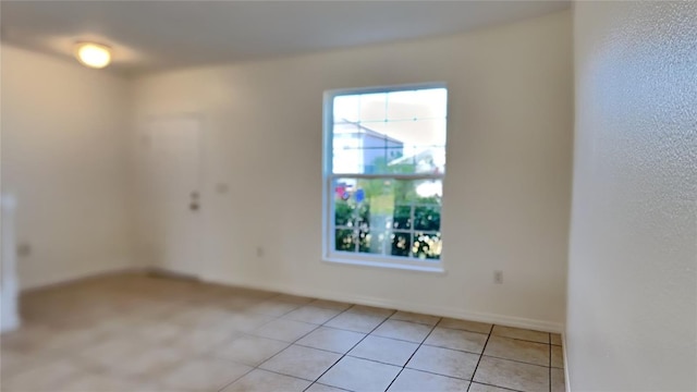 unfurnished room with light tile patterned floors