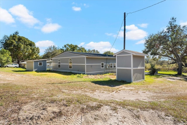 view of side of property featuring a storage unit