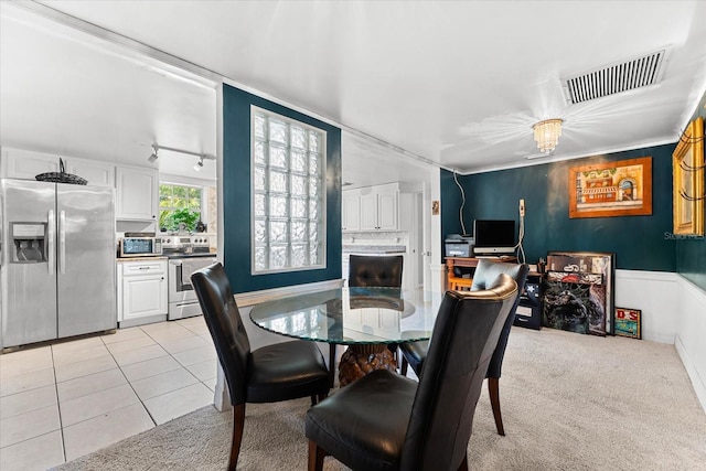 carpeted dining room with track lighting