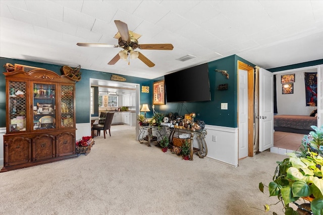 kitchen with light carpet and ceiling fan