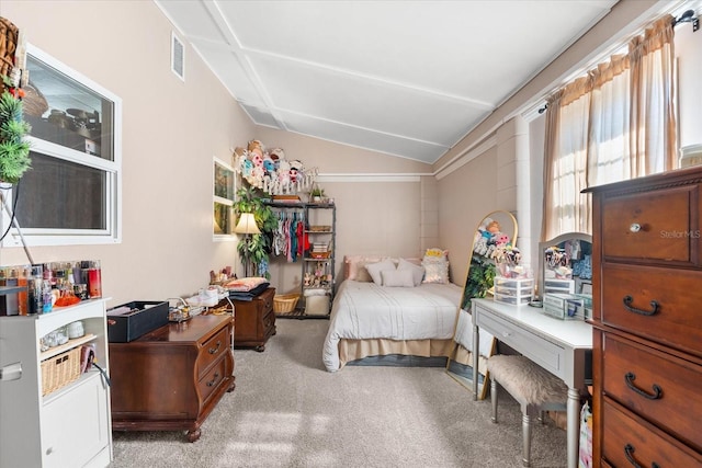 carpeted bedroom with lofted ceiling