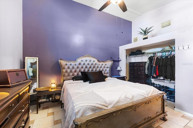 tiled bedroom featuring ceiling fan, a closet, and high vaulted ceiling