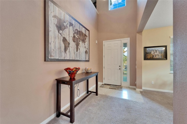 tiled foyer entrance with plenty of natural light and a high ceiling