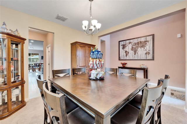 carpeted dining space featuring an inviting chandelier